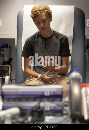 Carolinas MED 1 Mobile Hospital Unit provide medical aid to a patient, Colby Kornegay, in Burgaw, NC, Sept. 22, 2018. Carolinas MED-1 deployed to the city of Burgaw in response to rising water levels from Hurricane Florence which blocked access to available hospitals in Wilmington, NC. Spc. Cory Long/CAISE Stock Photo