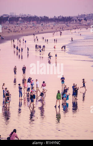 Crowds of people on Santa Monica Beach at sunset Stock Photo