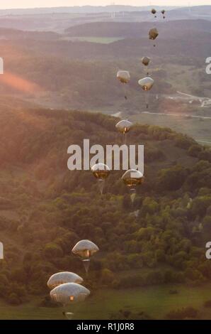 U.S. Army soldiers from the 173rd Airborne Brigade, as well as soldiers from various allied nations, parachute from U.S. Air Force C-130 aircraft onto a drop zone in Germany, Sept. 19, 2018. Saber Junction 18 is the U.S. Army 173rd Airborne Brigade’s combat training center certification exercise, taking place on the Grafenwoehr and Hohenfels training areas. The U.S. Army Europe-directed exercise is designed to assess the readiness of the brigade to conduct unified land operations in a joint, combined environment and to promote interoperability with participating allies and partner nations. Sab Stock Photo