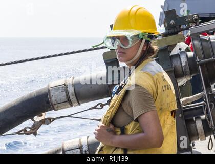 GULF OF ADEN (Sept. 20, 2018) Boatswain’s Mate 2nd Class Patricia M. Ortiz, from San Antonio, assigned to San Antonio-class amphibious transport dock ship USS Anchorage (LPD 23), participates in a replenishment-at-sea with dry cargo and ammunition ship USNS Alan Shepard (T-AKE 3) while on a regularly scheduled deployment of Essex Amphibious Ready Group (ARG) and the 13th Marine Expeditionary Unit (MEU). The Essex ARG/13th MEU is a lethal, flexible, and persistent Navy-Marine Corps team deployed to the U.S. 5th Fleet area of operations in support of naval operations to ensure maritime stability Stock Photo