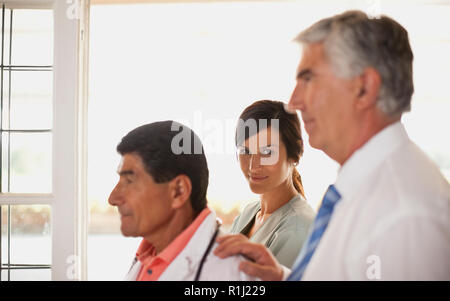 Portrait of two male doctors and a female nurse. Stock Photo