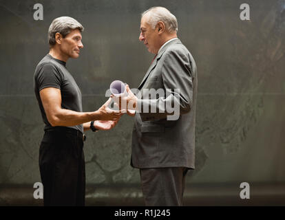 Architect handing blueprints to businessman. Stock Photo