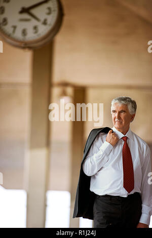 Senior businessman waiting in train station. Stock Photo
