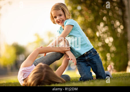 Two sisters playing in backyard. Stock Photo
