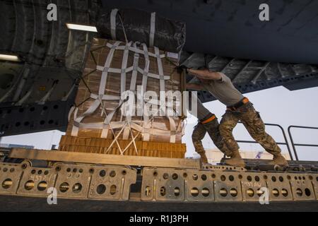Airmen with the 8th Expeditionary Air Mobility Squadron push class one sustainment pallets for a combat airdrop onboard a U.S. Air Force C-17 Globemaster III at Al Udeid Air Base, Qatar, Sept. 24, 2018. U.S. Air Forces Central Command Airmen, Joint personnel and Coalition partners provide airpower effects across U.S. Central Command’s 20-nation area of responsibility reaching from Egypt to Afghanistan. Stock Photo