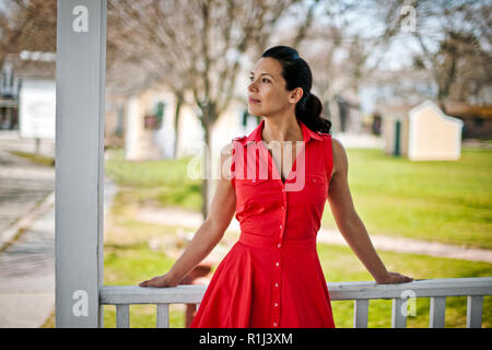 Woman stands on wooden deck. Stock Photo