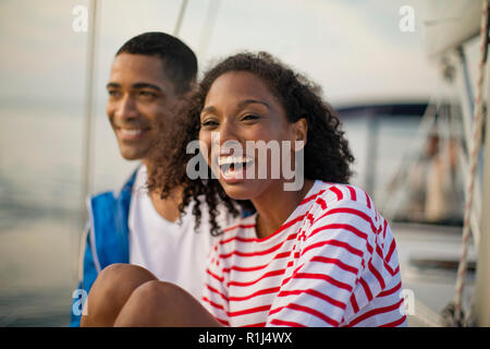 Young couple relaxing and having fun while sailing. Stock Photo