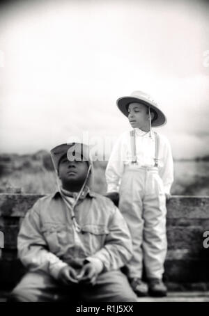 Front view of two kids wearing hats. Stock Photo