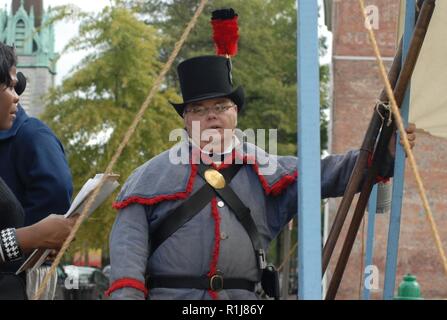 Historical re-enactors with the non-profit group Fort Norfolk and Frigate Constellation present a living history event during Museum Day on Saturday, October 6, 2018. The living history display was in conjunction with Museum Day, which is an event organized by the Olde Town Business Association in Downtown Portsmouth, Virginia. The living history display took place in front of a new mural which depicted the Battle of Craney Island; which took place on June 22, 1813. The new mural was recently painted by artist Sam Welty, and commissioned by the non-profit Support Portsmouth Public Art. Stock Photo