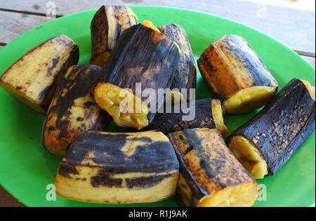 boiled bananas on green plate Stock Photo