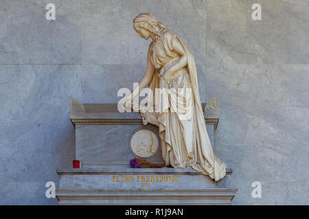 Zagreb, Croatia – October 2018. a white monument a sad girl in mooning at the city cemetery grave Stock Photo