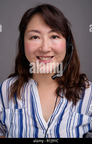 Portrait of Asian call center representative woman smiling Stock Photo