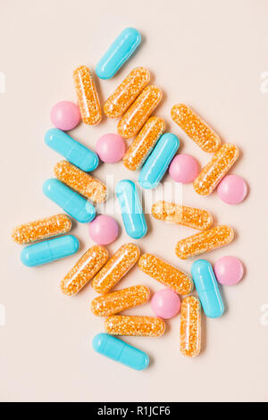 top view of various colorful pills on beige surface Stock Photo