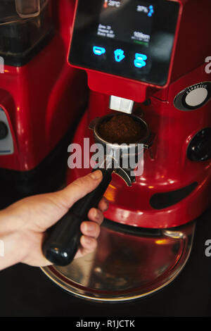 barista holding tamper above portafilter with grinded coffee, espresso, manual  press, arabica Stock Photo by LightFieldStudios