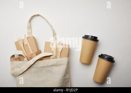 elevated view of cotton bag with food boxes and two disposable coffee cups on white surface Stock Photo