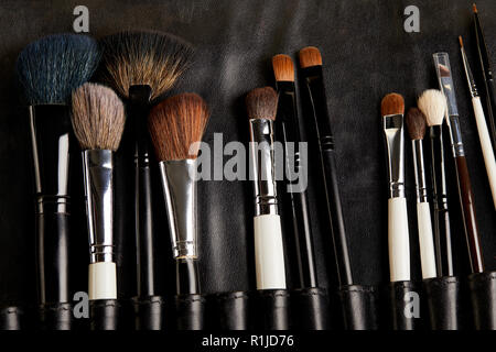 top view of leather holder with professional makeup brushes Stock Photo