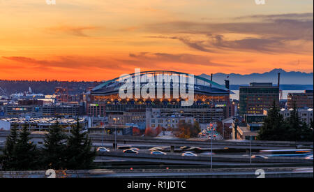 Seattle downtown and Safeco Field  beyond the I-5 I-90 freeway interchange at sunset in the fall with yellow foliage in the foreground view from Dr. J Stock Photo