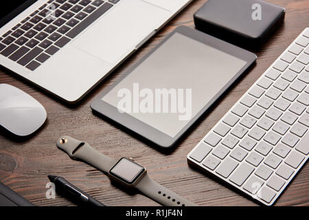 close-up shot of different modern gadgets on wooden table Stock Photo
