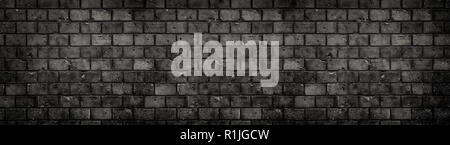 Old and weathered grungy black dark gray concrete block brick wall texture background with holes and cracks with vignetting in a large panoramic wide  Stock Photo