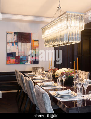 Pendant light over set dining table Stock Photo