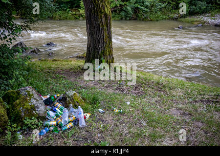 DEBNEVO, BULGARIA - JULY 26, 2018: Pile of plastic and metallic garbage, mostly beer cans and water bottles being left to pollute the riverbed after c Stock Photo