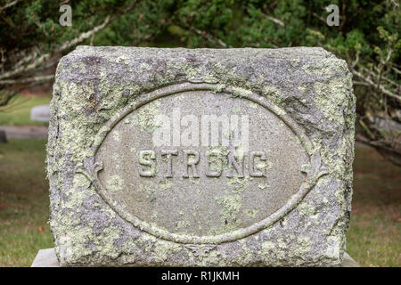 Weathered head stone with the last name Strong Stock Photo