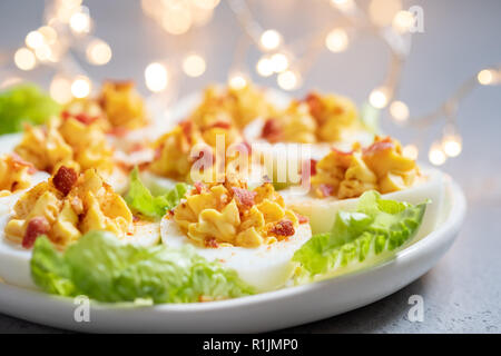 Healthy Deviled Eggs as an Appetizer with Bacon Stock Photo