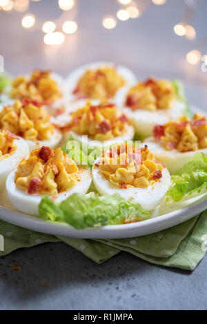 Healthy Deviled Eggs as an Appetizer with Bacon Stock Photo