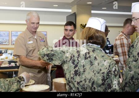 Capt. Carolyn Rice, NMCP's executive officer, serves ice cream to Capt. Christopher Culp, commanding officer, during the Annual Customer Service Appreciation Week ice cream social. Stock Photo