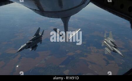 Two U.S. Air Force F-15C Eagles from the 144th Fighter Wing, Fresno Air National Guard Base, Calif., break away behind a KC-135 Stratotanker from RAF Mildenhall, England, after receiving fuel during Exercise Clear Sky over Romania, Oct. 10, 2018. The exercise is a joint and multinational exercise that involved approximately 950 personnel from nine nations. Stock Photo
