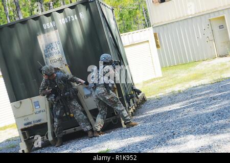 During a container delivery mission, two Soldiers with the 519th MP Bn are forced to take cover before advancing on the enemy, just one of several scenarios that tested the companies and platoons of the battalion during the exercise evaluation held Oct. 1-5. Stock Photo