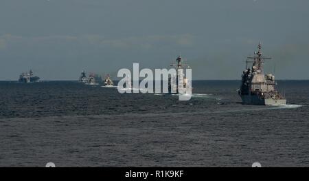 WATERS OFF THE KOREAN PENINSULA (Oct. 11, 2018) Multinational ships steam in formation during an exercise at the Republic of Korea (ROK) International Fleet Review (IFR) 2018. IFR 2018 is hosted by the Republic of Korea Navy to help enhance mutual trust and confidence with navies from around the world. The forward-deployed aircraft carrier USS Ronald Reagan (CVN 76) is forward-deployed to the U.S. 7th Fleet area of operations in support of security and stability in the Indo-Pacific region. Stock Photo