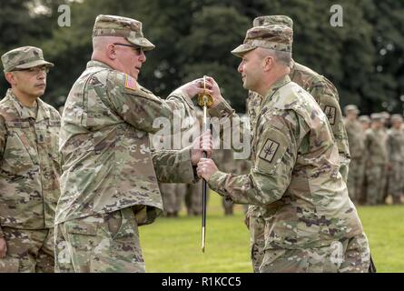 U.S. Army Brig. Gen. Michel Natali, commander, 53rd Troop Command, New York Army National Guard, passes the noncommissioned officer sword to Command Sgt. Maj. Thomas Ciampolillo, incoming command sergeant major of the 53rd Troop Command, during a change of responsibility ceremony at Camp Smith Training Site, Cortlandt Manor, N.Y., Oct. 14, 2018. The ceremony marked the change of the 53rd Troop Command’s senior enlisted advisor from outgoing Command Sgt. Maj. Corey K. Cush to incoming Command Sgt. Maj. Ciampolillo. Stock Photo