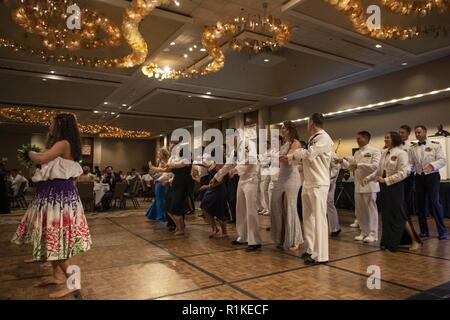 HONOLULU (Oct. 13, 2018) Sailors, families and guests learn to hula dance during the Navy Region Hawaii 243rd Navy Birthday Ball in Honolulu, Hawaii. The theme for the Navy's 243rd birthday is 'Forged by the Sea.' The theme represents the aspirational outcome of every Sailor's journey in uniform and conveys the notion that every Sailor is shaped and strengthened into a more capable version of themselves through Navy service. Stock Photo