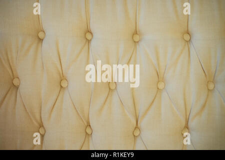 Texture,classic sofa upholstery with light fabric buttons. Stock Photo