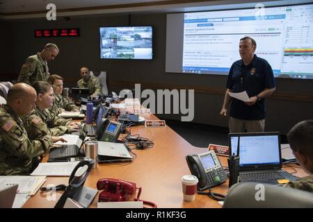 Steven Burton, emergency management specialists, briefs members of the Emergency Operations Center during the 2018 San Antonio Mass Casualty Exercise and Evaluation at Brooke Army Medical Center, Fort Sam Houston, Texas, Oct. 11, 2018. The exercise simulated an active shooter scenario to test the capabilities of hospitals and emergency responders in the San Antonio area. ( Stock Photo