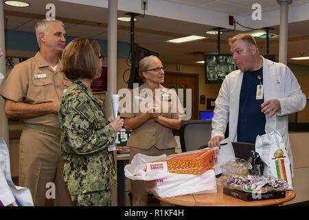– An NMCP midwife talks to Capt. Carolyn Rice, NMCP’s executive officer; Capt. Christopher Culp, NMCP’s commanding officer, and Capt. Dixie Aune, Director of Nursing Services, during an appreciation breakfast for National Midwifery Week. Stock Photo
