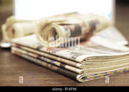 Pile of fresh morning newspapers on the table at office. Latest financial  and business news in daily paper (1) –