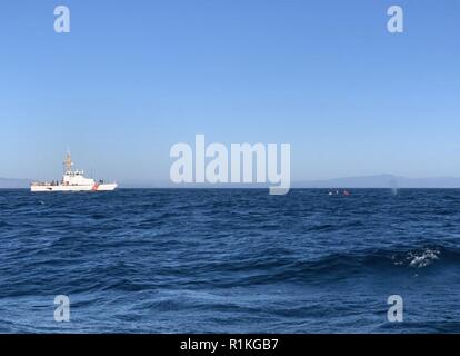 Coast Guard Cutter Hawksbill, an 87-foot Coastal Patrol Boat homeported in Monterey, California, assists NOAA personnel with the disentanglement of a whale three miles southwest of Santa Cruz, Oct. 15, 2018. NOAA requested assistance from the Coast Guard to locate the whale and to enforce a safety zone to keep vessels away from the whale during the disentanglement. Stock Photo