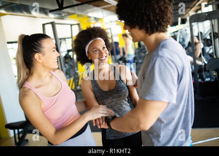 Happy gorup of healthy people training in gym Stock Photo