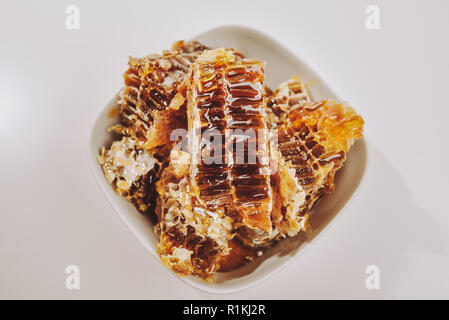 Pieces of honeycomb. Honeycombs in a wooden frame with full cells of honey sealed with wax Stock Photo