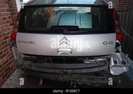 Rear end of a written off crash damaged citroen c4 car on a recovery trailer Stock Photo