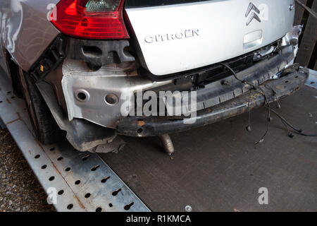 Rear end of a written off crash damaged citroen c4 car on a recovery trailer Stock Photo