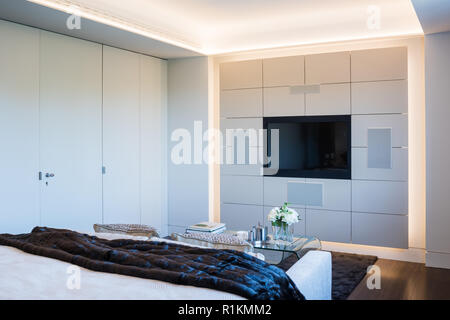 Flat panel television in panel in bedroom Stock Photo