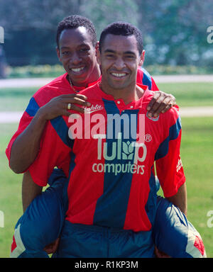 Mark Bright (Crystal Palace) wearing the team's new strip showing their new sponsor, Tulip Computers, carries teammate Ian Wright during a photocall at the Football Association's Lancaster Gate headquarters. Stock Photo