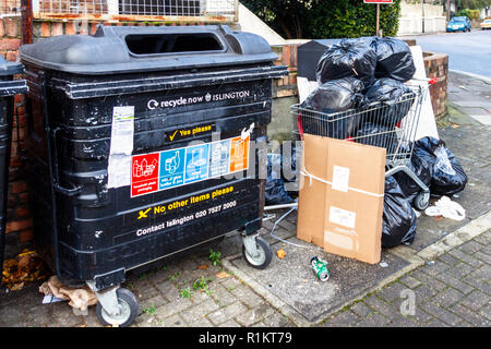 Overflowing recycling bins and dumped rubbish in Islington, London, UK Stock Photo