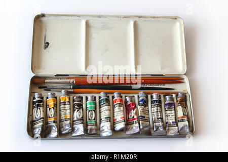 Used set of aquarelle and some paintbrushes in metal box, close-up Stock Photo