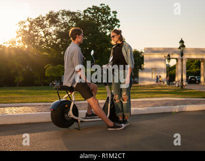 Lovely young happy couple with electric bike Stock Photo