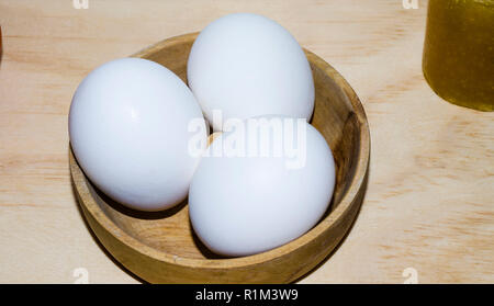 dish with three white eggs Stock Photo