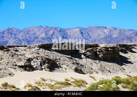 Parched river bed on the background of mountains and sky Stock Photo